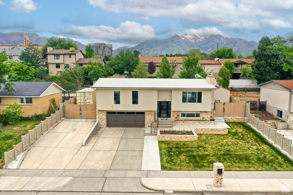 Split foyer home with a gate, a mountain view, and a residential view