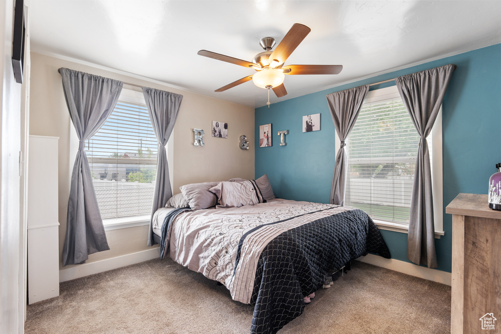 Bedroom with carpet floors, ceiling fan, and baseboards