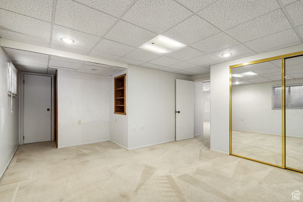 Finished below grade area featuring carpet floors, a paneled ceiling, and recessed lighting