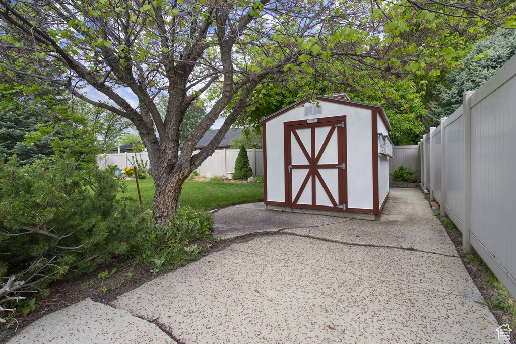 View of shed with a fenced backyard