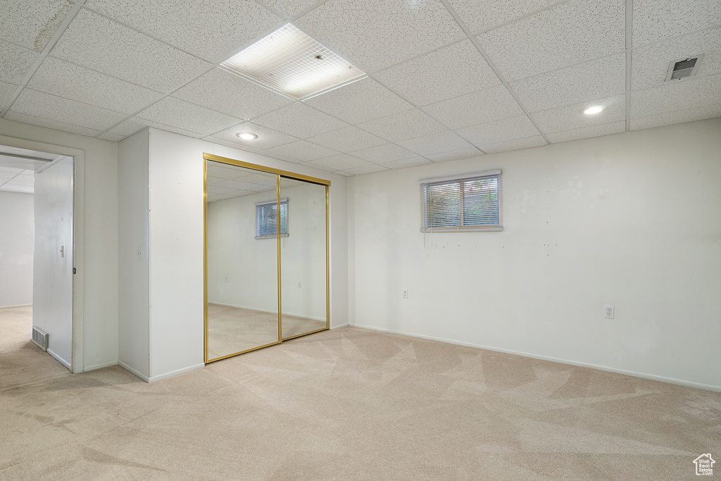 Unfurnished bedroom with a paneled ceiling, carpet, recessed lighting, a closet, and baseboards