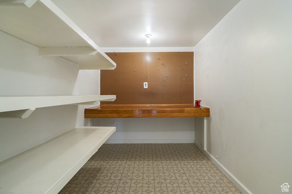 Walk in closet featuring light floors