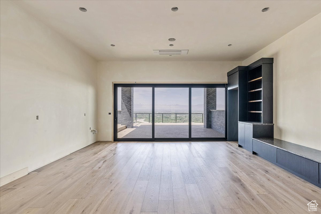 Unfurnished living room featuring light wood-style floors