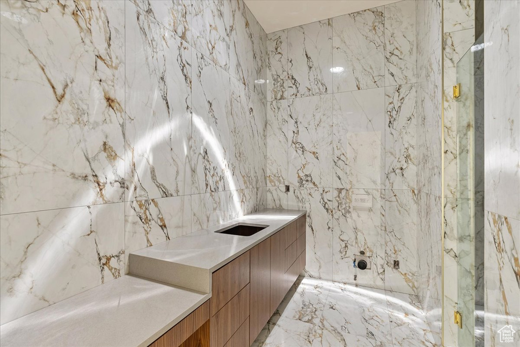 Bathroom with tile walls and marble tiled flooring