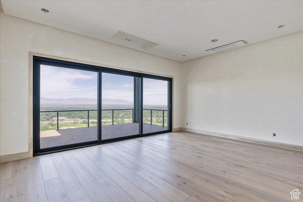 Spare room with wood finished floors and baseboards