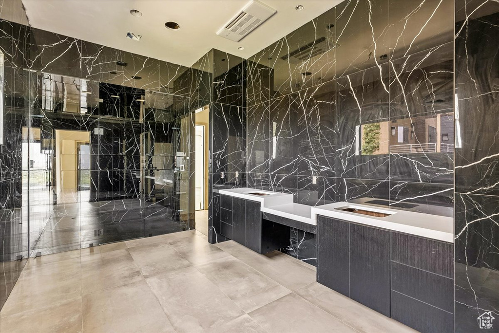 Bathroom with tile walls and vanity