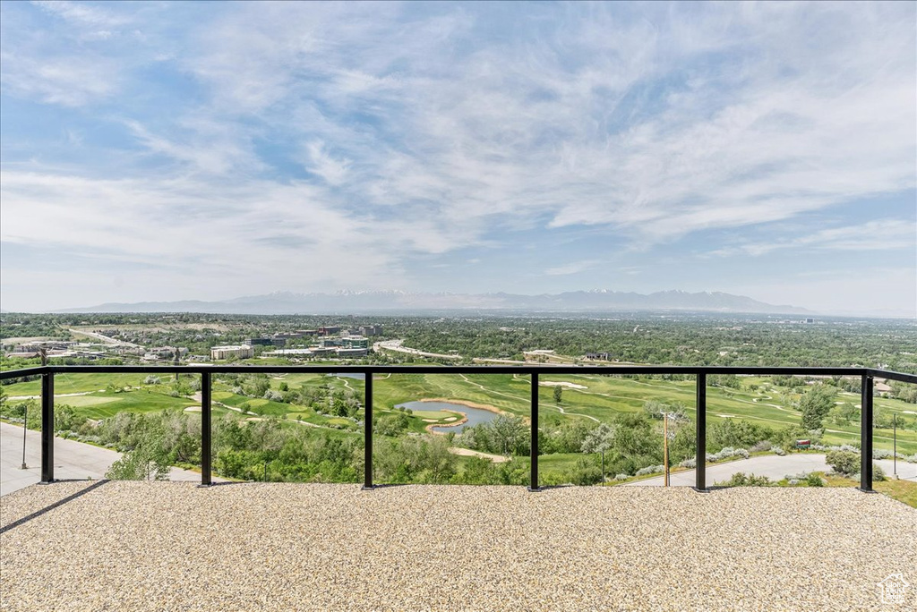 Balcony featuring a water and mountain view