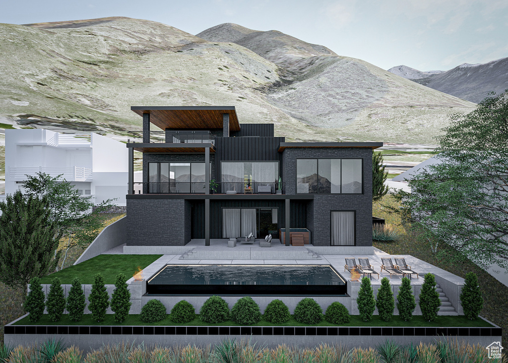 Rear view of property featuring a balcony and a mountain view