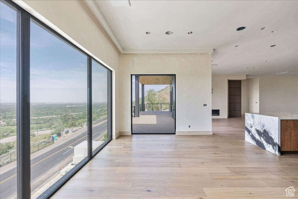 Spare room featuring light wood-style flooring, baseboards, and recessed lighting