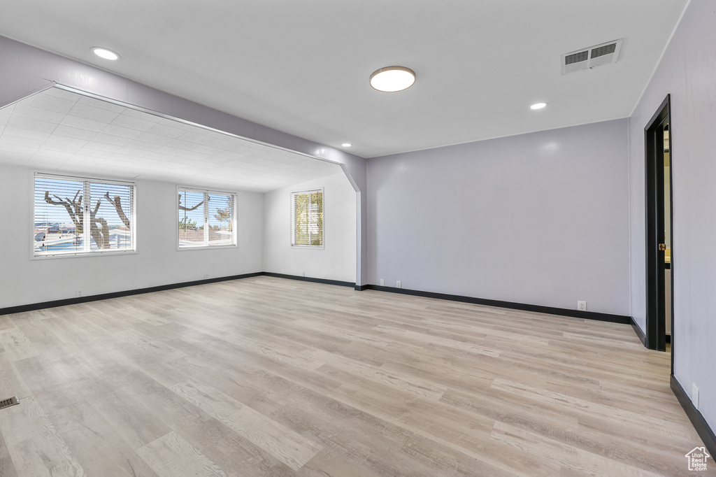 Spare room featuring baseboards, light wood finished floors, and recessed lighting