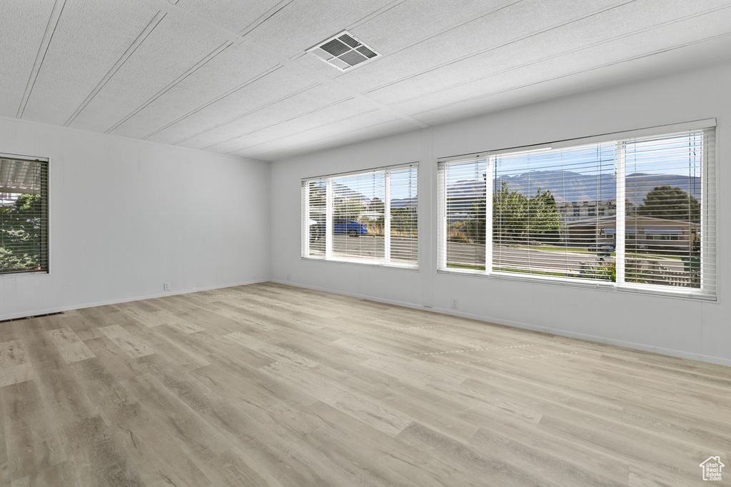 Unfurnished room with light wood-type flooring and baseboards