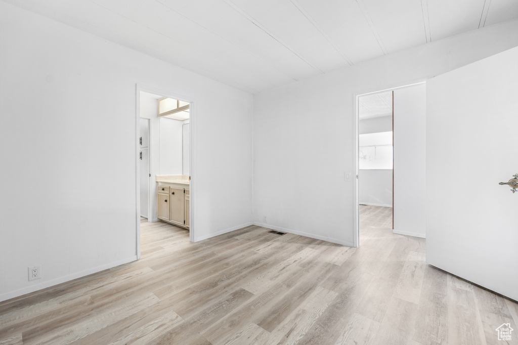 Empty room featuring light wood-type flooring and baseboards