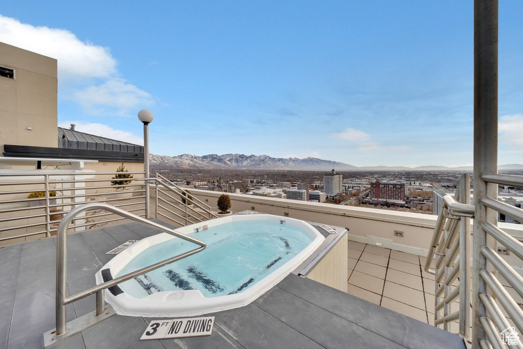 View of swimming pool featuring a mountain view and a hot tub