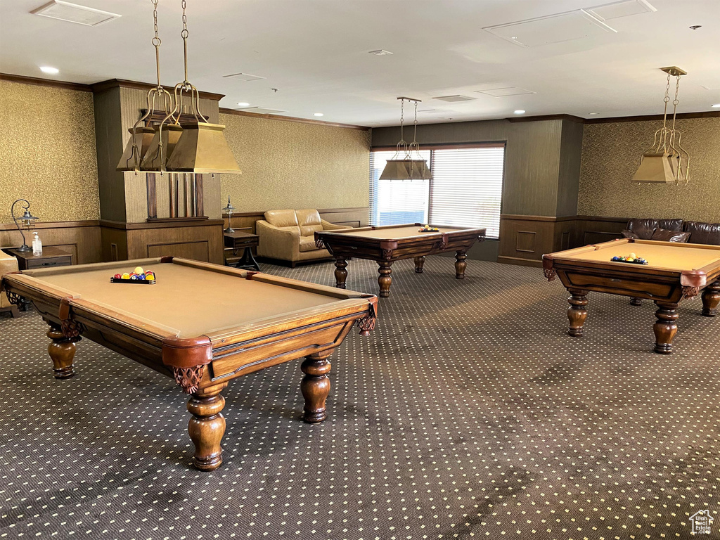 Rec room with billiards table, wallpapered walls, wainscoting, carpet floors, and ornamental molding