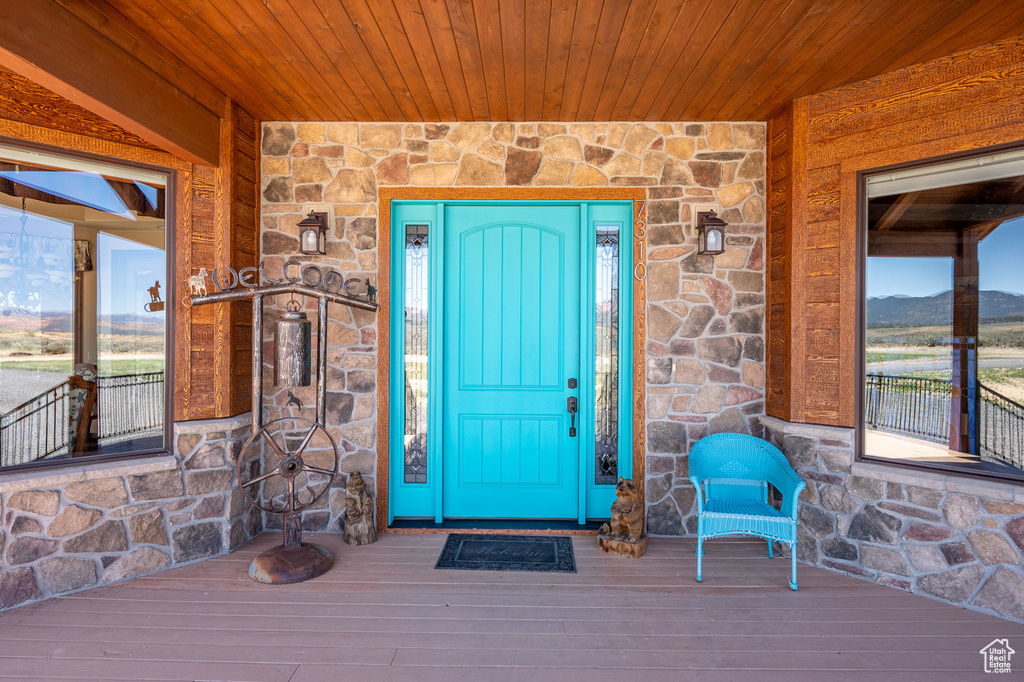 View of exterior entry with stone siding and a mountain view