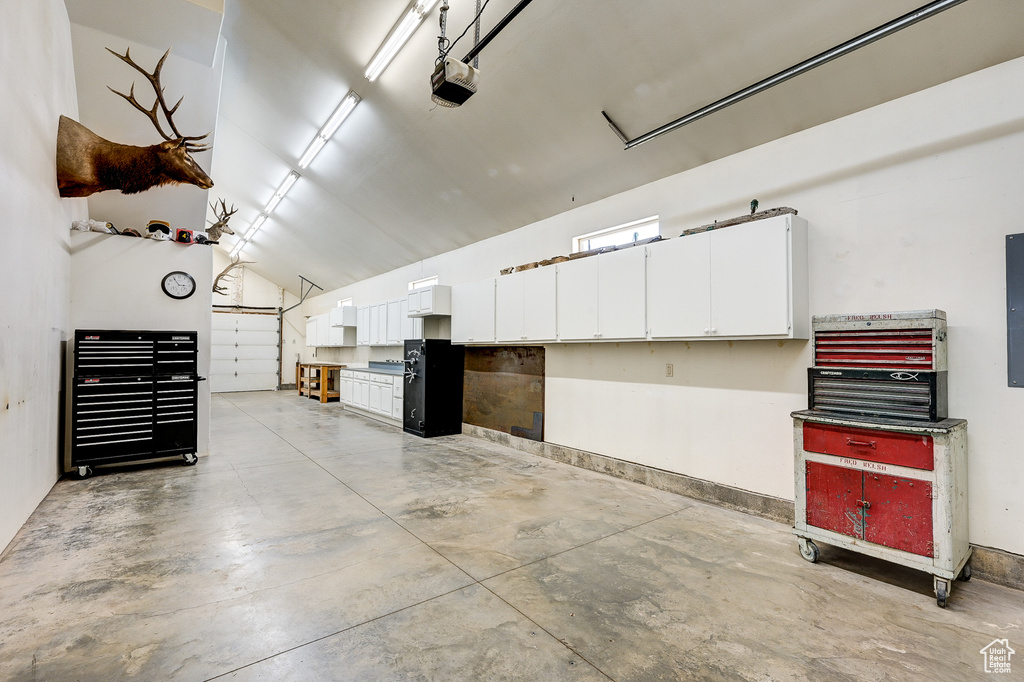 Garage with a garage door opener and a workshop area