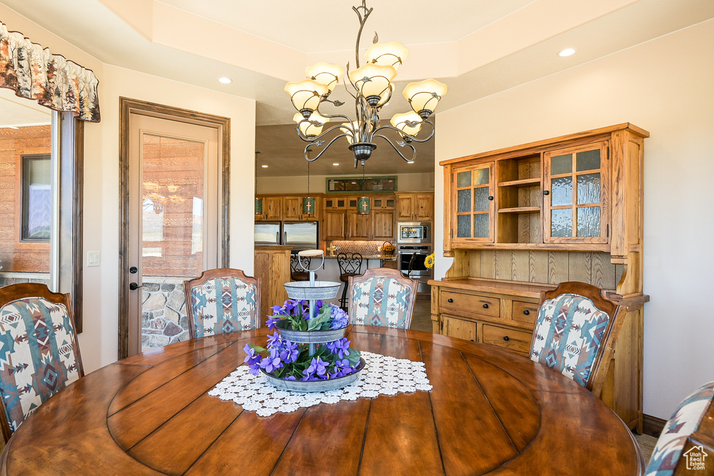 Dining space featuring a chandelier and recessed lighting