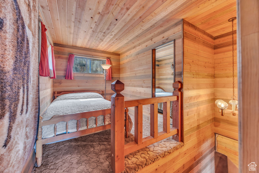 Bedroom with wooden ceiling and wood walls