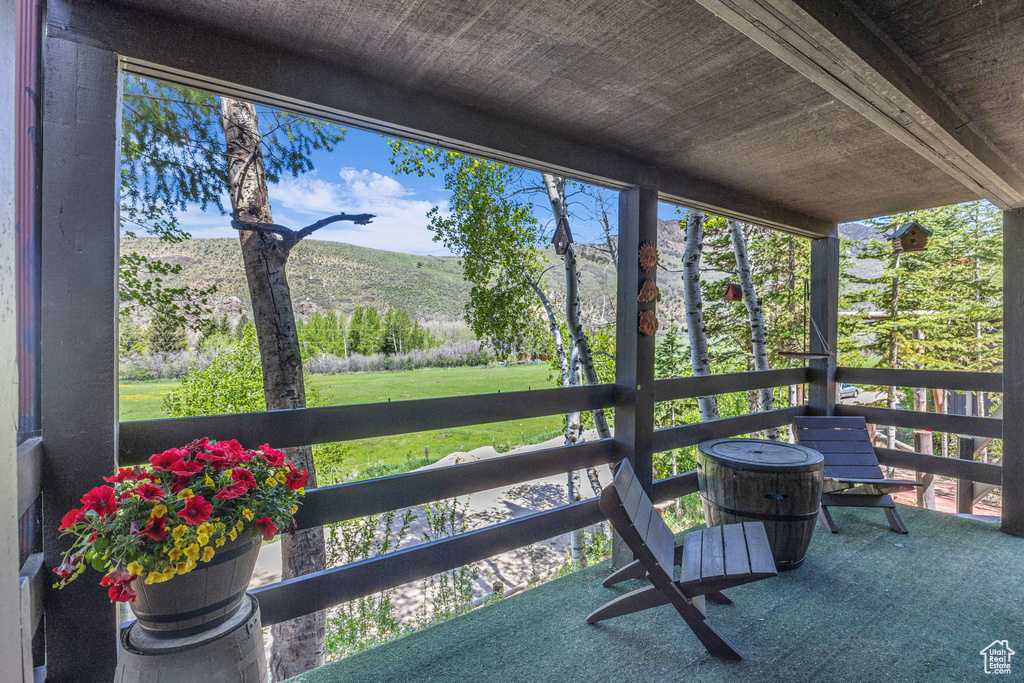 Sunroom / solarium with a mountain view and healthy amount of natural light