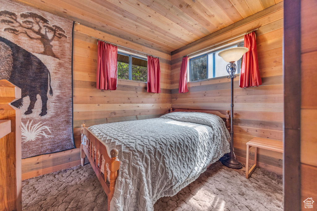 Bedroom with wood walls and wood ceiling