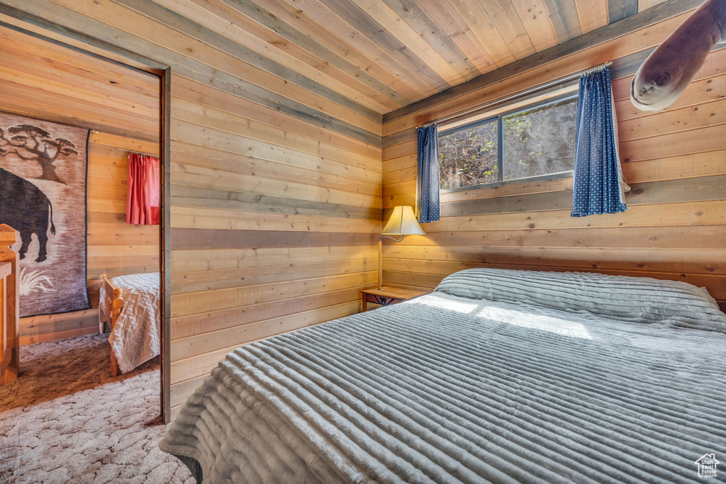 Bedroom with wooden walls and wooden ceiling