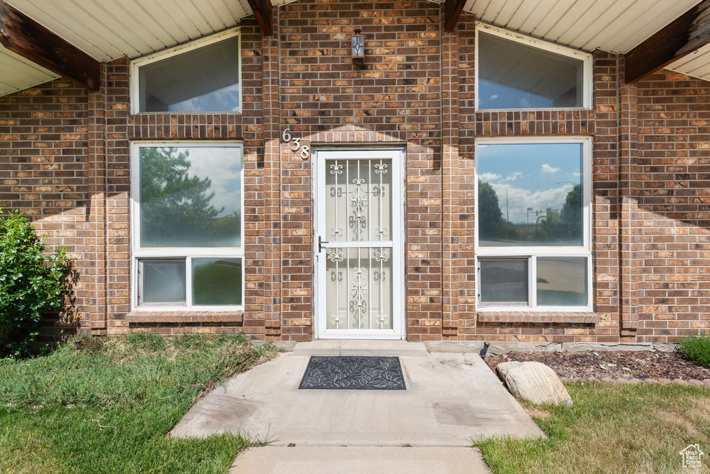 Property entrance featuring brick siding