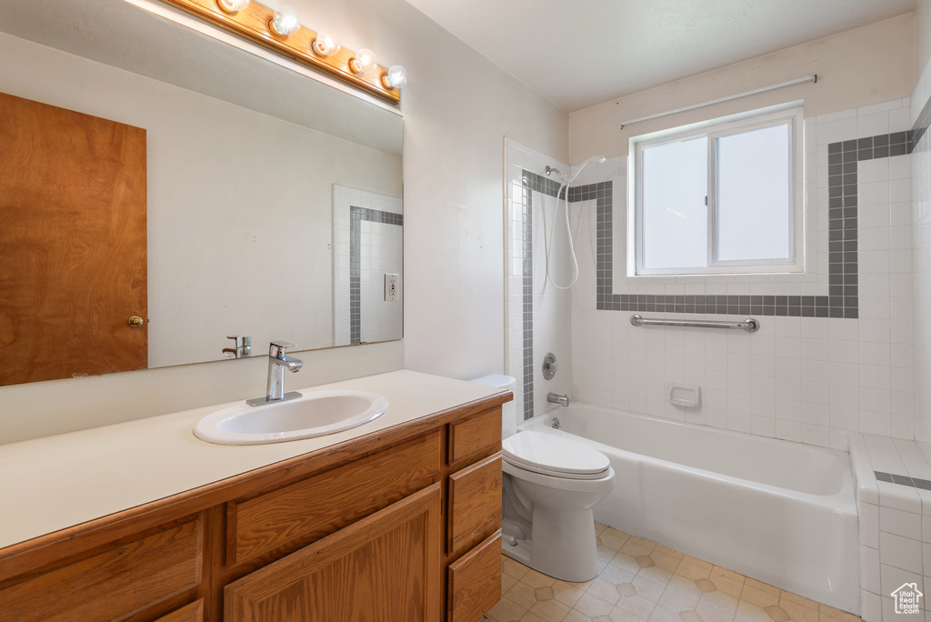 Full bath featuring tile patterned floors, bathing tub / shower combination, toilet, and vanity