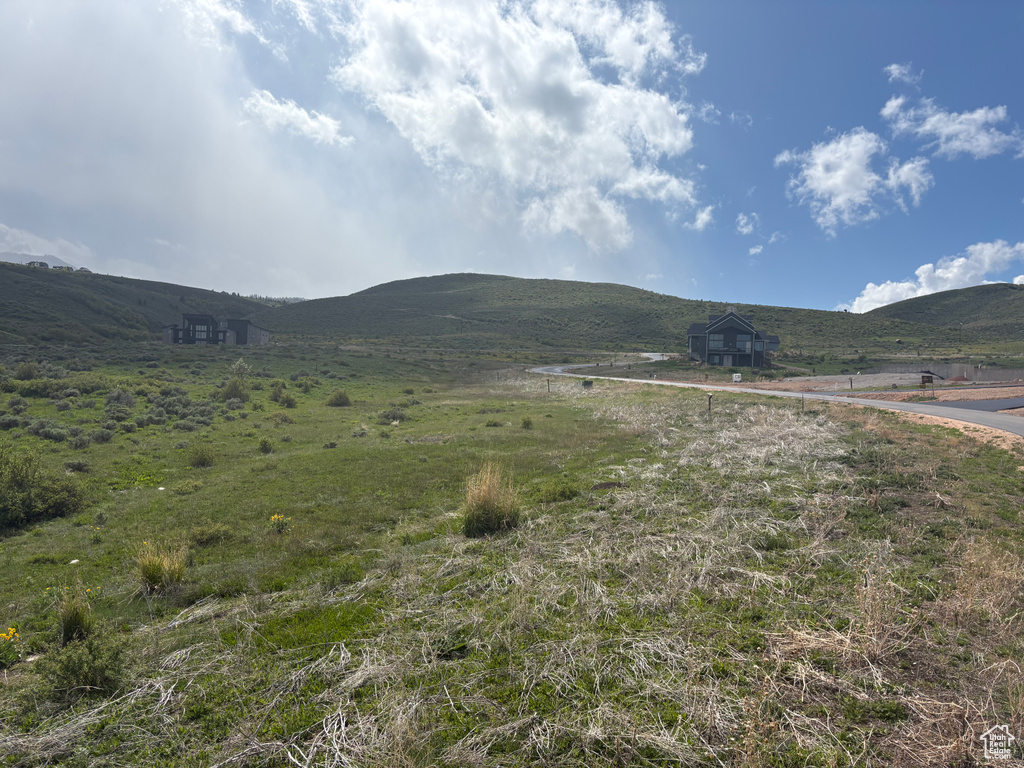 View of mountain backdrop with rural landscape