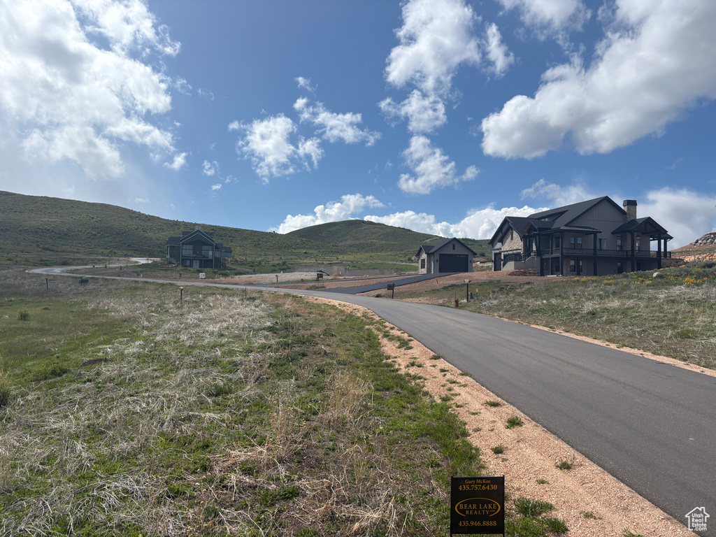 View of asphalt street featuring a mountain view and a view of rural / pastoral area