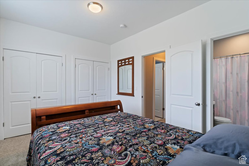 Bedroom with carpet flooring and multiple closets
