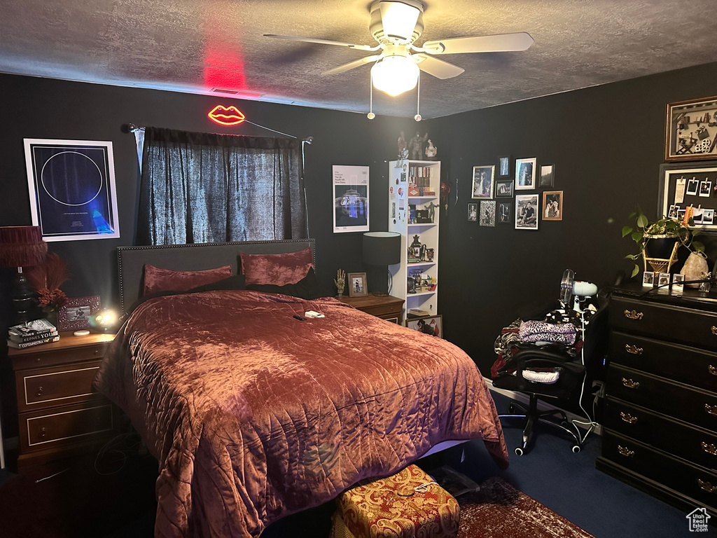 Bedroom featuring a textured ceiling and a ceiling fan