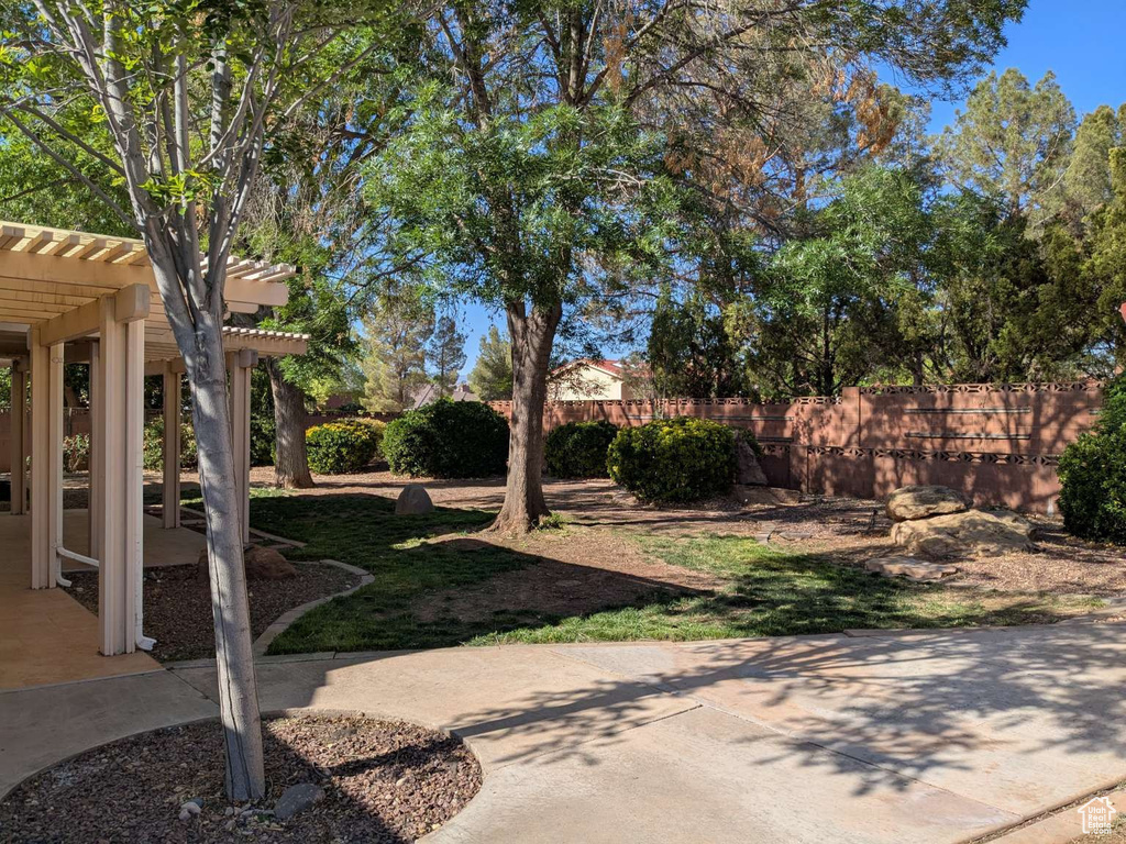 View of yard with a pergola and a patio
