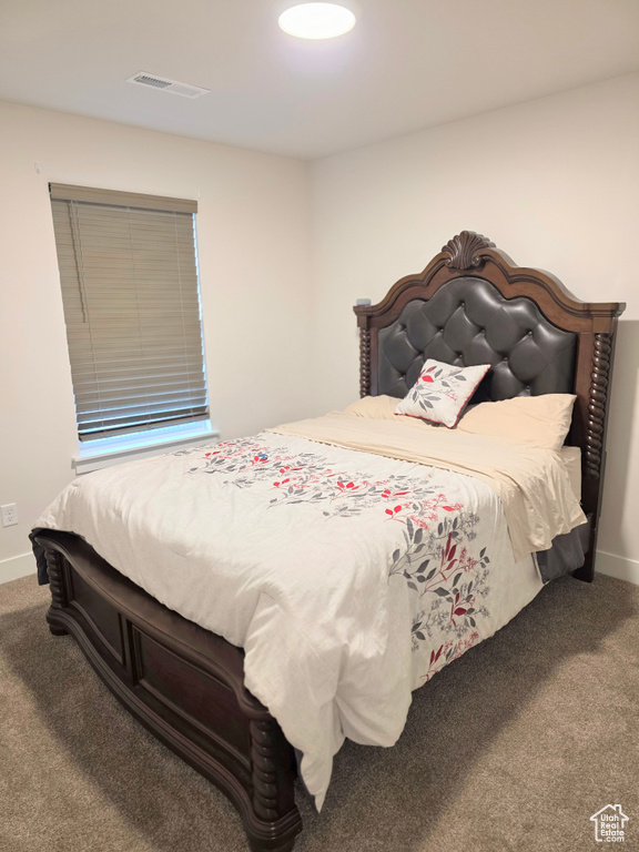 Bedroom with carpet flooring and baseboards
