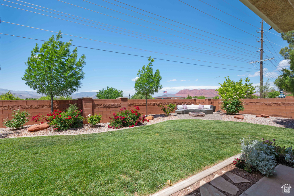 View of yard with an outdoor living space and a mountain view