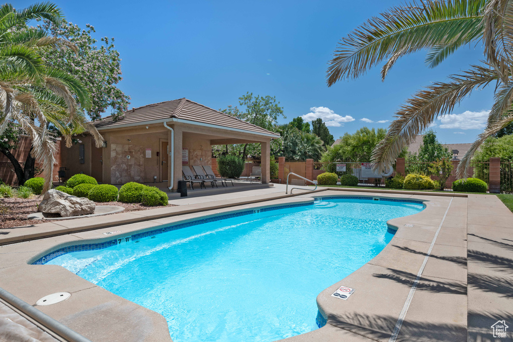 Community pool featuring a patio, fence, and a gazebo