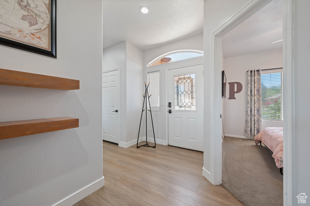 Entrance foyer featuring light wood finished floors and baseboards