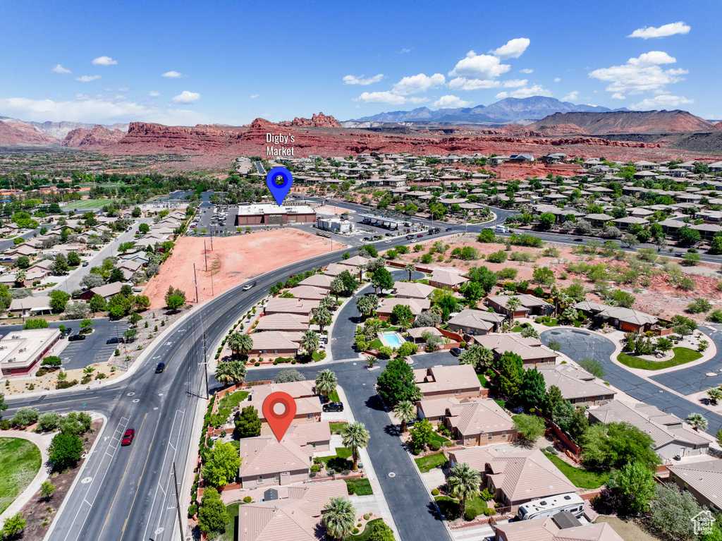 Aerial overview of property's location with mountains and nearby suburban area
