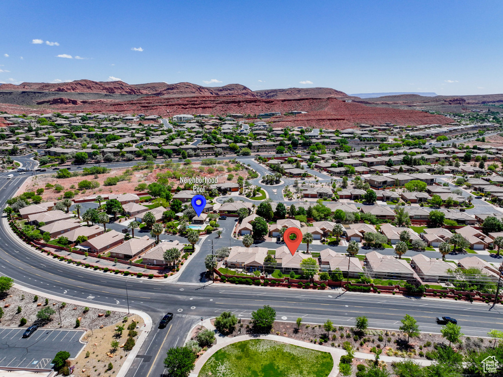 Aerial overview of property's location with a mountainous background and nearby suburban area