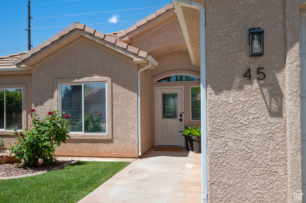 Property entrance featuring stucco siding