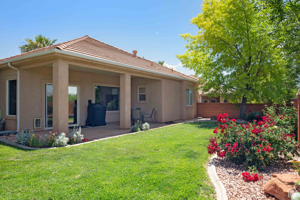 Back of house with stucco siding, a patio, and a tiled roof