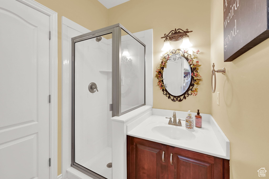Bathroom with a stall shower and vanity