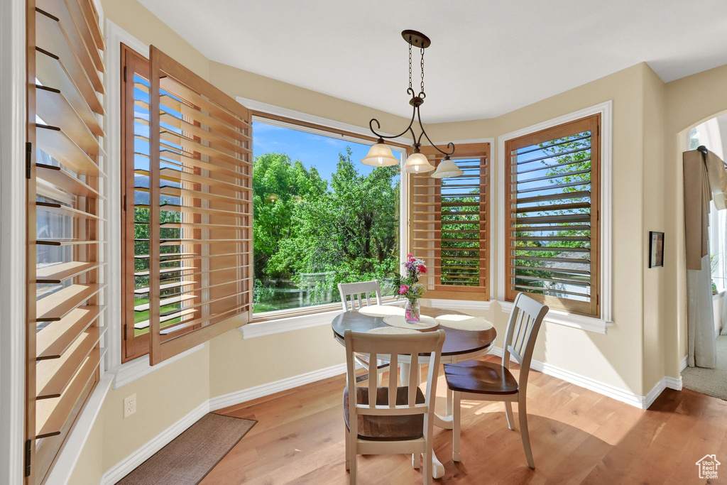 Dining area featuring healthy amount of natural light, light wood-style flooring, and baseboards