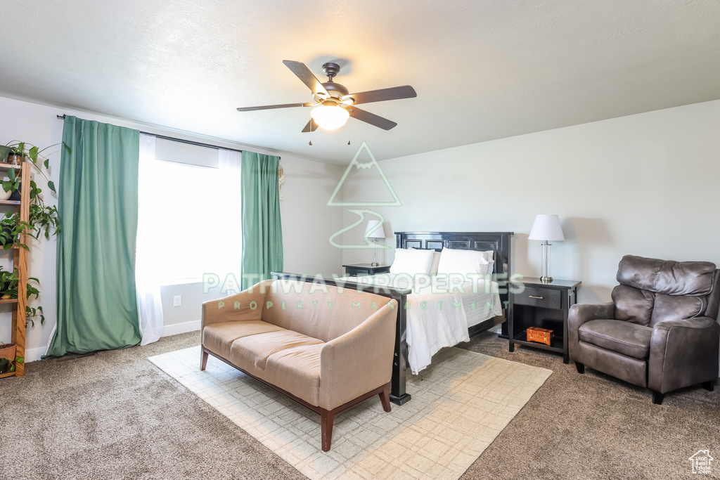Carpeted bedroom with ceiling fan