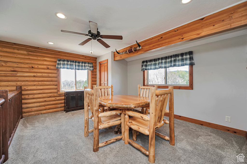 Dining space with a ceiling fan, recessed lighting, light colored carpet, log walls, and baseboards