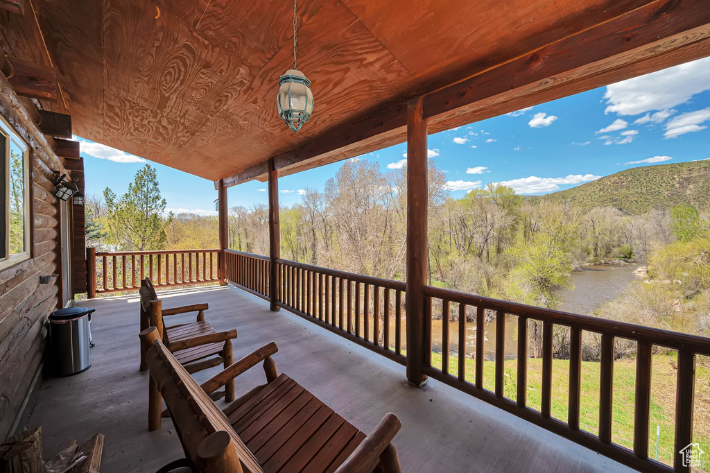 Wooden deck with a mountain view and a forest view