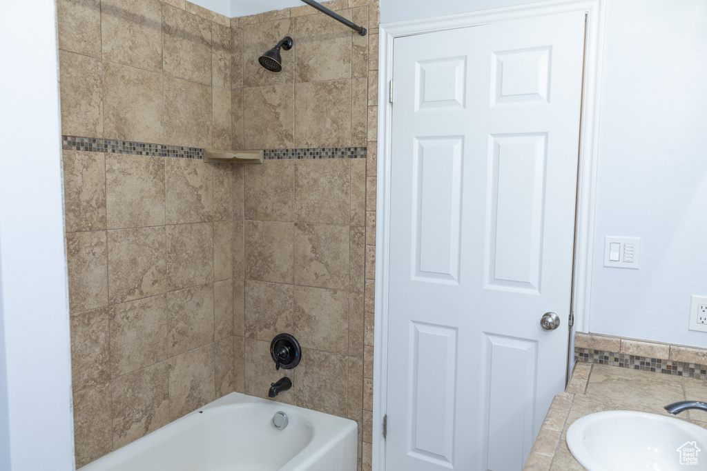 Bathroom with a sink and shower / bath combination