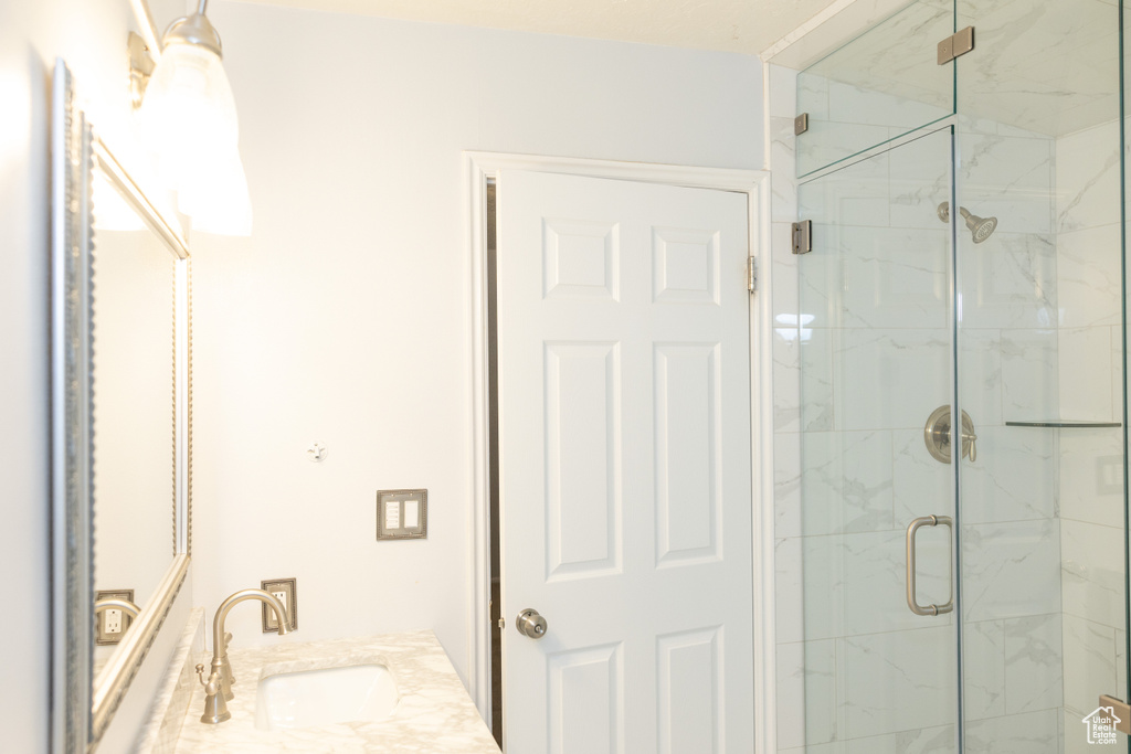 Bathroom with a sink and a marble finish shower