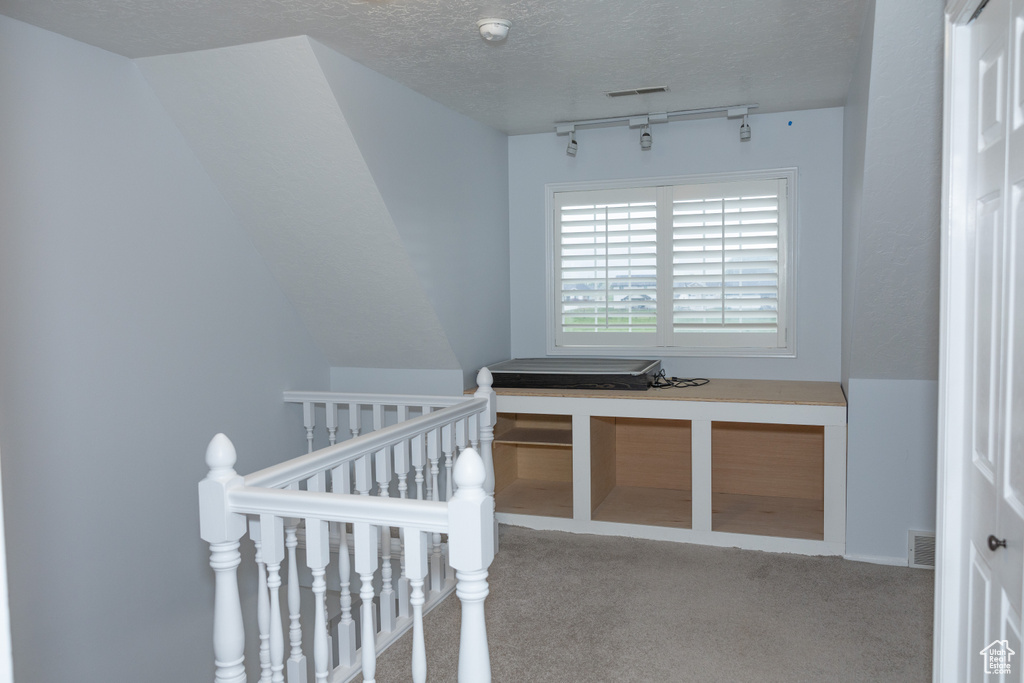 Bedroom with carpet and a textured ceiling