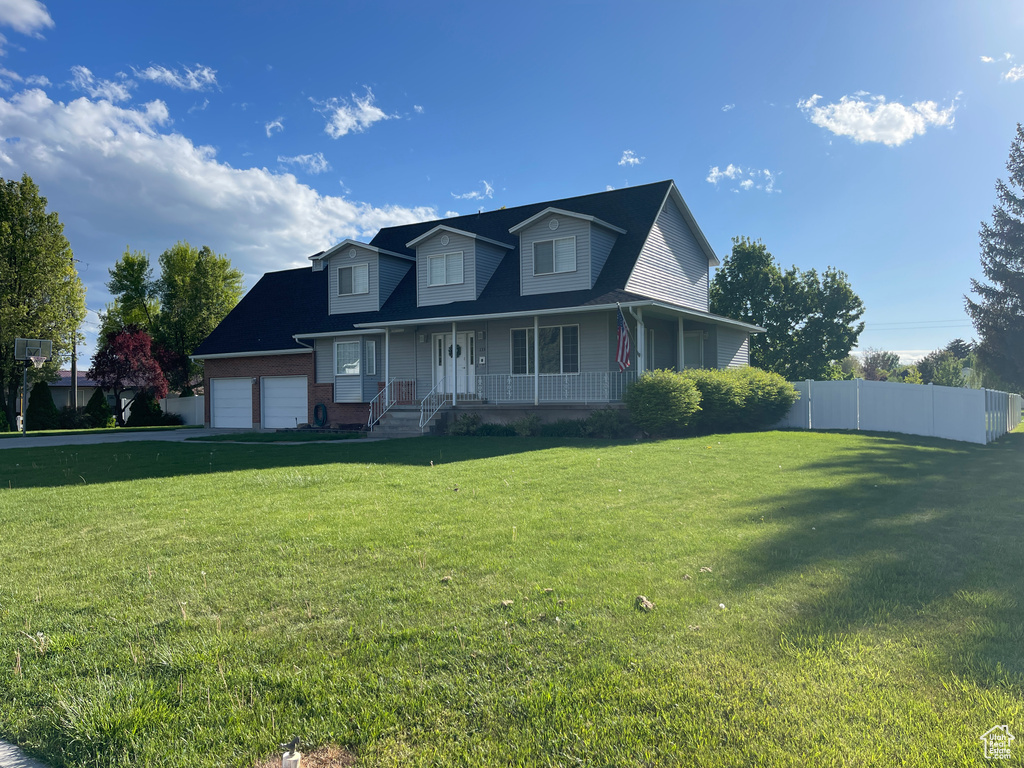 View of front of property featuring covered porch and a garage