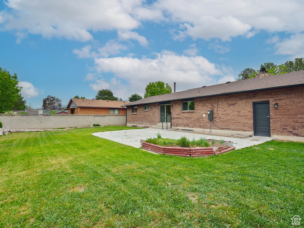 Back of house featuring a patio and brick siding